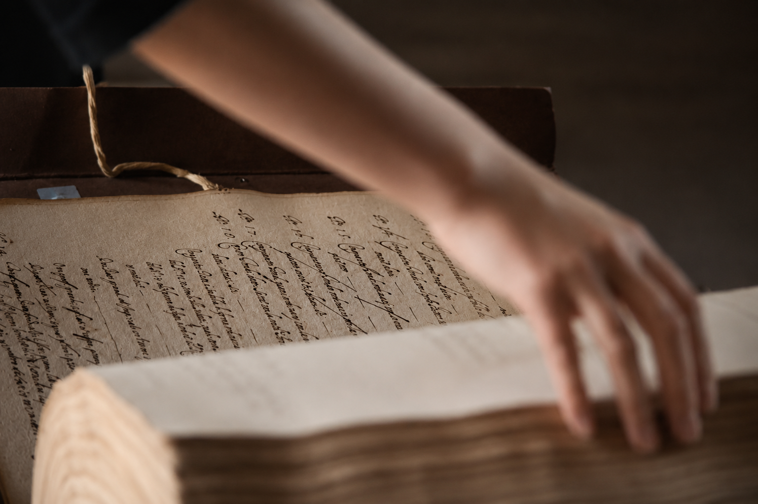 Provenance Evidence Matrix and Archival Manuscript Research Provenance evidence matrix research context, showing handwritten archival pages in focus with a researcher’s hand turning a manuscript page.